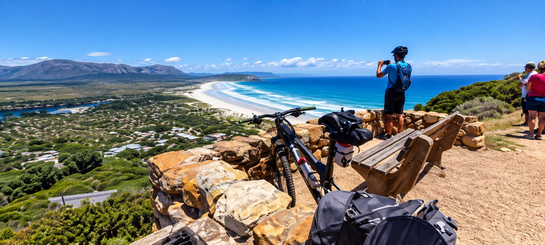 Cyclist with mountain bike enjoying panoramic coastal views during a scenic cycling tour.